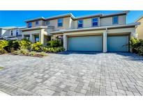 Two-story house with two-car garage and landscaped front yard at 2477 Shanti Dr, Kissimmee, FL 34746