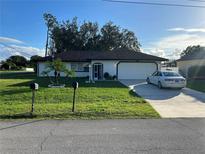 Single-story home with attached garage and well-manicured lawn at 602 Mesilla Dr, Kissimmee, FL 34758