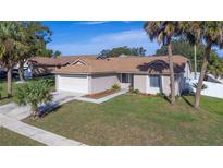Single-story house with a garage and well-maintained lawn at 7393 Radiant Cir, Orlando, FL 32810