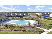 Community pool with lounge chairs and playground nearby at 4704 Homestead Trl, St Cloud, FL 34772