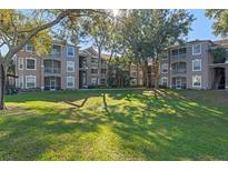 Residential building with landscaped grounds at 7135 Yacht Basin Ave # 237, Orlando, FL 32835