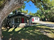 Charming bungalow with stone accents and a red door at 221 N Julia Ave, Deland, FL 32720