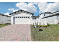 Two-story house with a two-car garage and a brick driveway at 520 Kennedy Dr, Lake Alfred, FL 33850