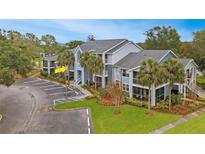 Attractive condo building with ample parking and lush landscaping at 2612 Grassy Point Dr # 202, Lake Mary, FL 32746