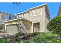 Two-story house with a two-car garage and landscaping at 471 Lasso Dr, Kissimmee, FL 34747