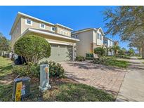 Two-story house with a two-car garage and landscaped yard at 471 Lasso Dr, Kissimmee, FL 34747