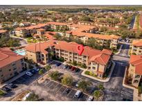 Aerial view showing the condo building's location and surrounding area at 903 Charo Pkwy # 836, Davenport, FL 33897