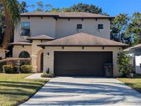 Two-story house with a two-car garage and landscaped lawn at 1720 Crocker Ave, Orlando, FL 32806