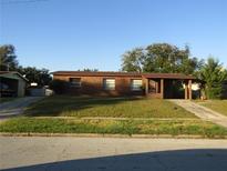 Brick house with carport and large yard at 3301 Wolcott Pl, Orlando, FL 32805