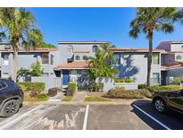 Inviting exterior of a two-story condo with landscaping and parking at 4715 Capri Pl # 191, Orlando, FL 32811