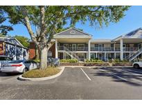 Two-story building with multiple units, ample parking, and landscaping at 5417 Lake Margaret Dr # G, Orlando, FL 32812
