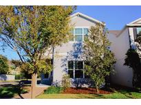 Two-story house with gray siding, landscaping, and a walkway at 8311 Lookout Pointe Dr, Windermere, FL 34786