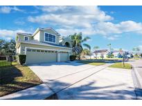 Two-story house with three car garage and landscaped yard at 2338 Darlin Cir, Orlando, FL 32820