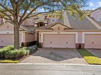Attractive two-story townhome with two-car garage and landscaped front yard at 8336 Riverdale Ln, Davenport, FL 33896