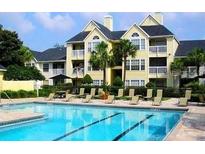 Community pool with apartment building in background at 1023 S Hiawassee Rd # 4022, Orlando, FL 32835