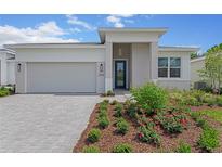 New single-story home with gray siding, white trim, and a paved driveway at 1258 Venice Ct, Deland, FL 32724