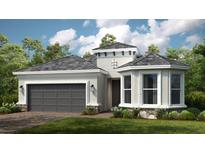 Single-story home with gray roof, attached garage, and landscaping at 857 Arbor Green Trl, St Cloud, FL 34771