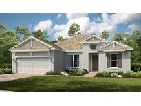 One-story home with gray siding, a gable roof, and a two-car garage at 919 Tassleflower Trl, St Cloud, FL 34771
