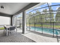 Enjoy this screened-in pool and spa with a patio area at 4428 Kaipo Rd, Davenport, FL 33897
