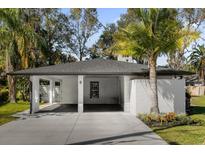 Updated home exterior with carport and landscaping at 8 Pine Ct, Yalaha, FL 34797