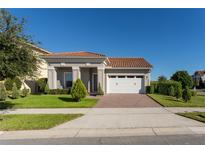 One-story home with tile roof, two-car garage, and well-manicured lawn at 13219 Stanthorne Ave, Orlando, FL 32832