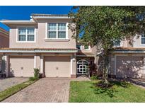 Two-story townhome with two-car garage and landscaped front yard at 8345 Bella Tierra Ct # 8345, Davenport, FL 33896