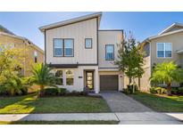 Modern two-story home with attached garage and landscaped lawn at 2759 Bookmark Dr, Kissimmee, FL 34746