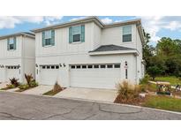 Two-story townhome with attached garage and landscaping at 2920 Oak Park Way # Apt A, Orlando, FL 32822