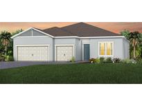 Single-story home with a two-car garage and attractive landscaping at 1623 Green Orchard St, St Cloud, FL 34771