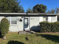 Ranch style home with front yard and hedges at 1805 Riley Ave, Orlando, FL 32805