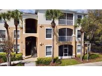 Two-story condo building with palm trees and balconies at 3190 Dante Dr # 304, Orlando, FL 32835