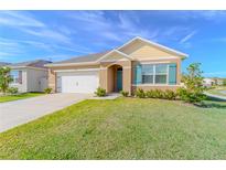 Suburban home with a two-car garage and well-manicured lawn at 3974 Mekong Ct, Saint Cloud, FL 34772