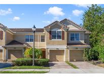 Two-story townhome with attached garage and landscaping at 6810 Hochad Dr, Orlando, FL 32819