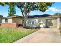 Charming one-story home with attached garage and brick accent wall at 2015 Patrick St, Kissimmee, FL 34741