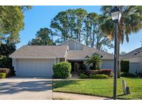 Single story home with attached two-car garage and landscaped yard at 2538 Long Iron Ct, Longwood, FL 32779