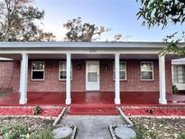 Brick home with covered porch and landscaped yard at 2205 12Th Nw St, Winter Haven, FL 33881