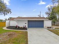 Newly renovated home with fresh landscaping and a modern garage door at 3553 Greenfield Ave, Orlando, FL 32808