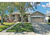 One-story home with a two-car garage and landscaped yard at 1965 Fairway Loop, Kissimmee, FL 34746