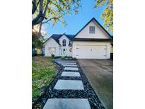 Two-story house with white exterior, stone walkway, and attached two-car garage at 4143 Shadow Creek Cir, Oviedo, FL 32765