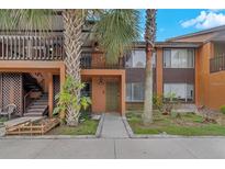 Exterior view of condo building with palm trees and walkway at 1234 Sago Palm Blvd # 1234, Kissimmee, FL 34741