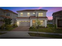 Two-story house with gray siding, brown roof, and a two-car garage at 13333 Oakenshaw Ln, Orlando, FL 32832