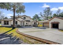 Two-story house with attached garage and a circular driveway at 168 Bethel Oaks Ln, Deltona, FL 32738