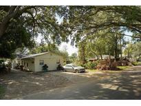 Ranch-style home with carport and mature landscaping at 3910 W Washington St, Orlando, FL 32805