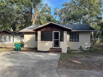 Charming bungalow home with a spacious front yard and mature trees at 1730 N Orange St, Mount Dora, FL 32757