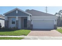 One-story home with gray siding, brick accents, and a two-car garage at 6116 Success Way, St Cloud, FL 34771