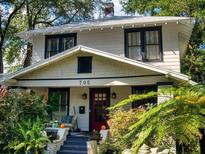 Charming two-story home with a red front door and well-manicured landscaping at 705 E Pine St, Orlando, FL 32801
