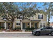 Two story townhome with front yard landscaping and a gray SUV parked in front at 7321 Brightland St, Windermere, FL 34786