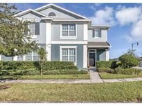 Two-story house with gray siding, landscaping, and a welcoming front porch at 4700 Nathan Hale Blvd, St Cloud, FL 34769