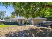 Single-story home with a carport and well-manicured lawn at 59 Pine Dr, Debary, FL 32713