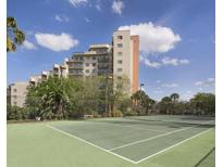 Tennis court with building in the background at 6165 Carrier Dr # 2103, Orlando, FL 32819